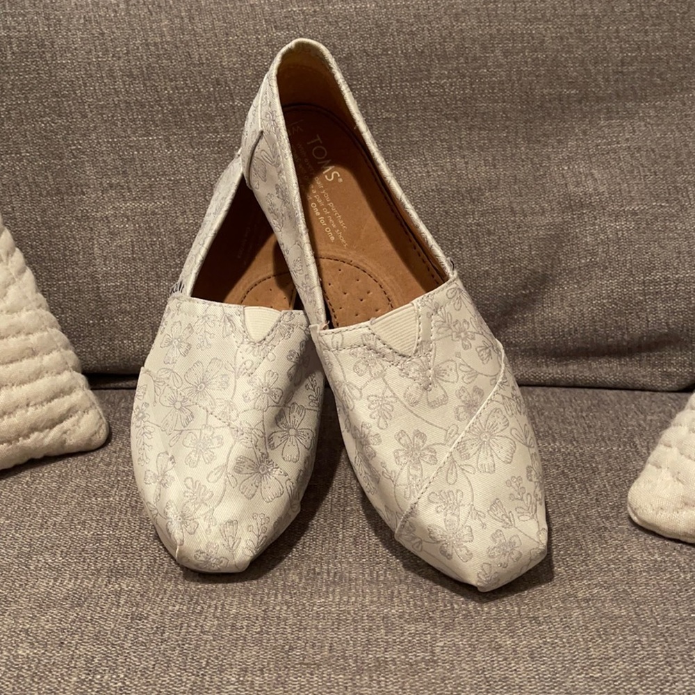 Silver and white Toms shoes